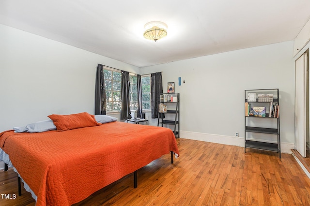 bedroom with hardwood / wood-style flooring