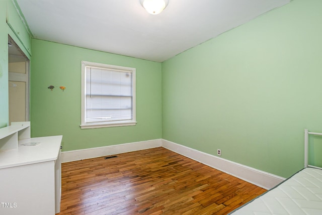 unfurnished bedroom with wood-type flooring