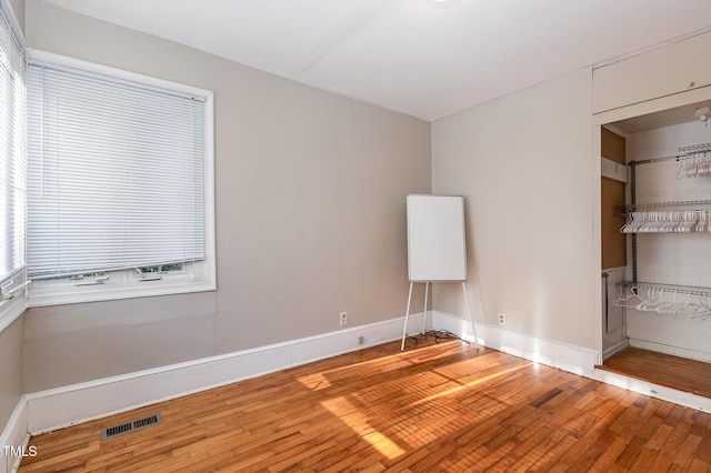 spare room featuring wood-type flooring