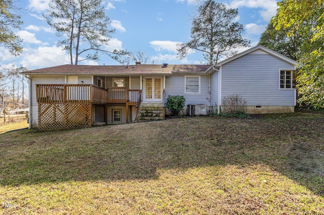 rear view of house featuring a lawn, cooling unit, and a wooden deck