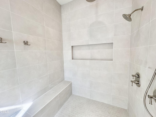 bathroom with a tile shower