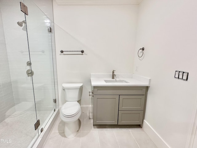 bathroom featuring toilet, tile patterned floors, vanity, and a shower with shower door