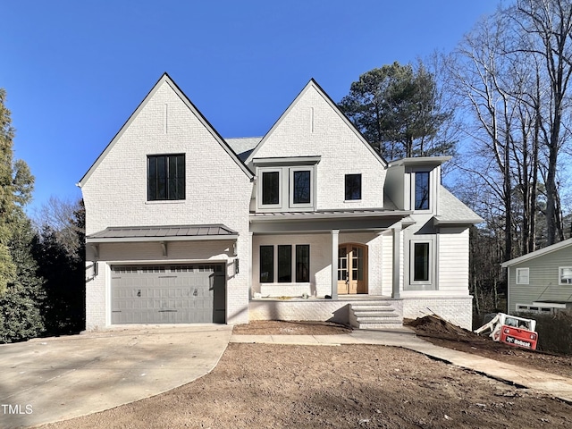 view of front of house featuring a porch and a garage