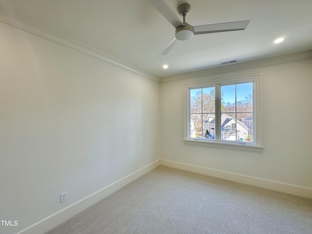 spare room featuring ceiling fan, carpet floors, and crown molding