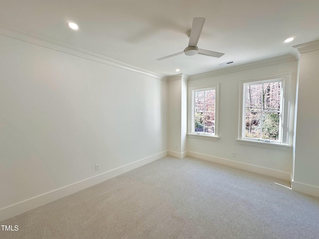 carpeted spare room with ceiling fan and crown molding