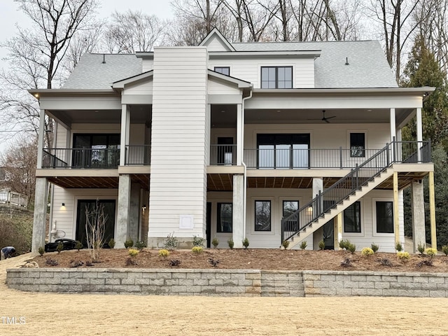 view of front of property with ceiling fan and a balcony