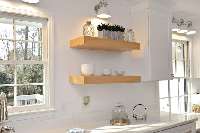 kitchen featuring white cabinetry and hanging light fixtures