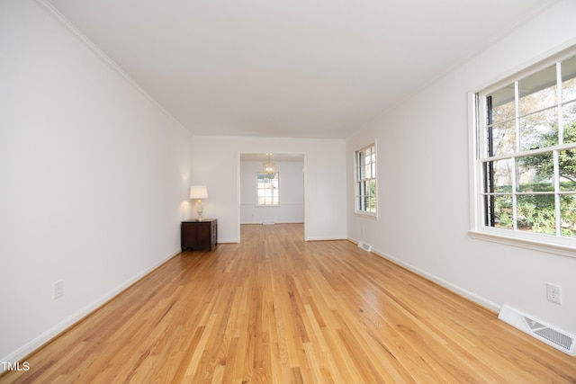 unfurnished room with light wood-type flooring