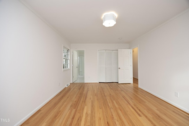 unfurnished bedroom with light hardwood / wood-style floors and a closet