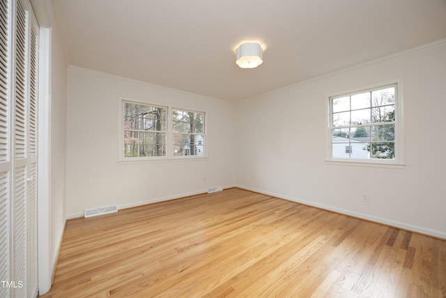 unfurnished bedroom featuring light hardwood / wood-style floors and crown molding