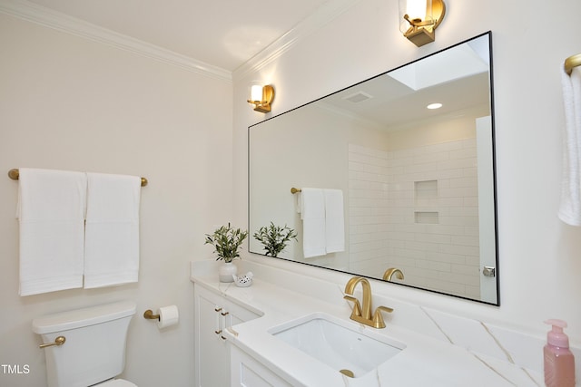 bathroom with vanity, toilet, crown molding, and a skylight