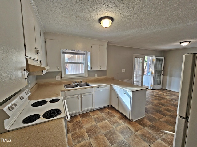 kitchen with white appliances, white cabinetry, plenty of natural light, and sink