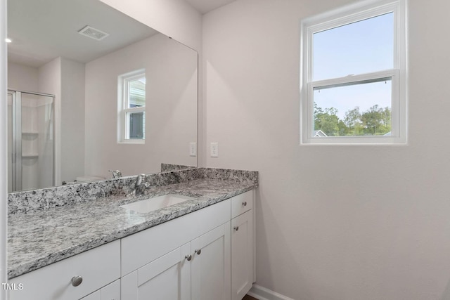 bathroom featuring vanity, toilet, and walk in shower