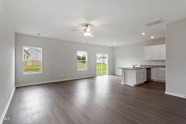 unfurnished living room with dark hardwood / wood-style floors, ceiling fan, and sink