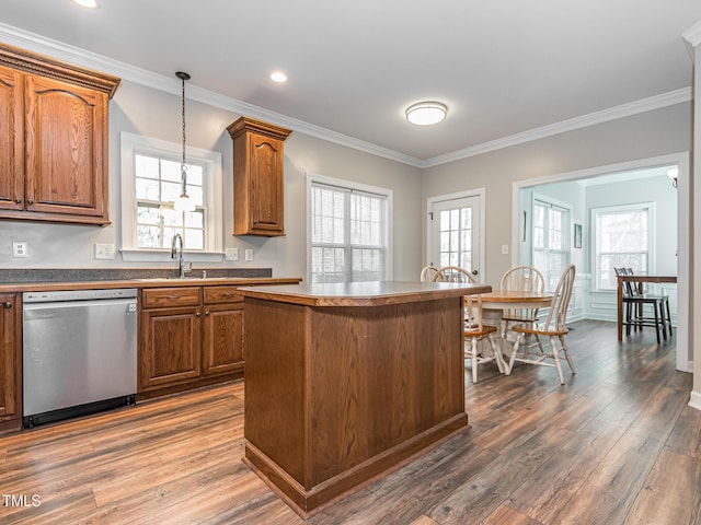 kitchen with hanging light fixtures, brown cabinetry, a kitchen island, wood finished floors, and dishwasher