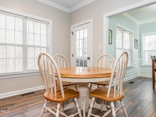 dining room with a healthy amount of sunlight, visible vents, and ornamental molding