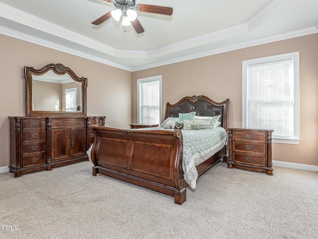 bedroom featuring light carpet, crown molding, a ceiling fan, and baseboards