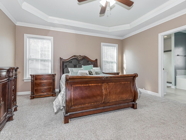 bedroom featuring light carpet, baseboards, a ceiling fan, ensuite bath, and crown molding