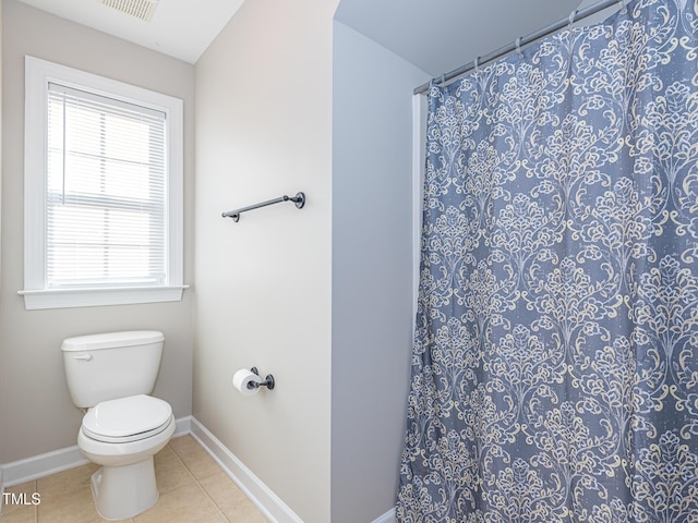 bathroom featuring tile patterned flooring, baseboards, toilet, and curtained shower