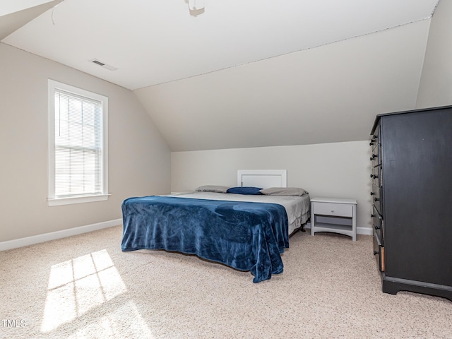 bedroom featuring lofted ceiling, baseboards, and visible vents