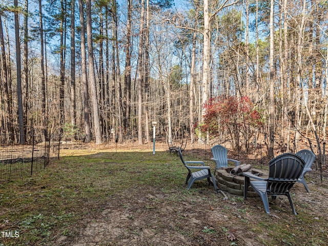 view of yard with an outdoor fire pit and fence