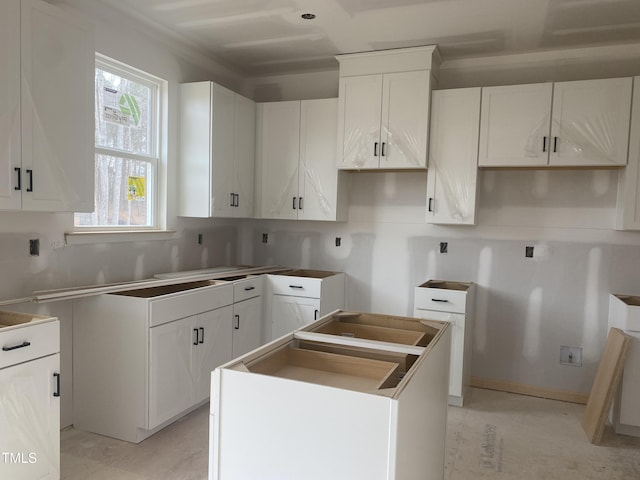 kitchen with a kitchen island and white cabinets