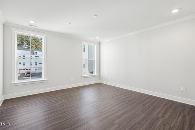 empty room featuring crown molding and dark hardwood / wood-style floors