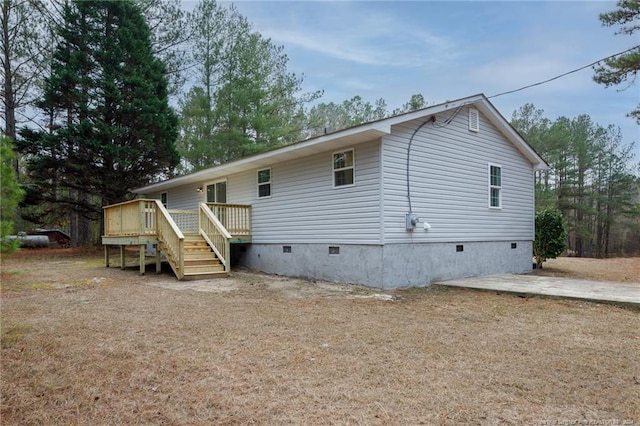 back of house featuring stairs, a wooden deck, and crawl space