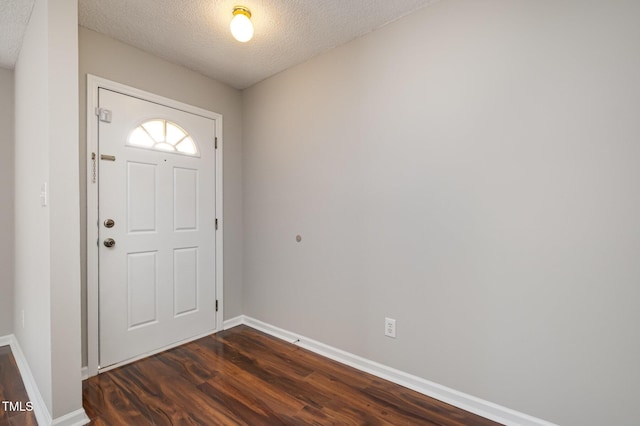 entryway featuring a textured ceiling and dark wood-type flooring