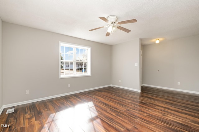 unfurnished room featuring a textured ceiling, ceiling fan, and dark wood-type flooring