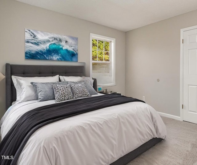 bedroom featuring carpet flooring and a textured ceiling