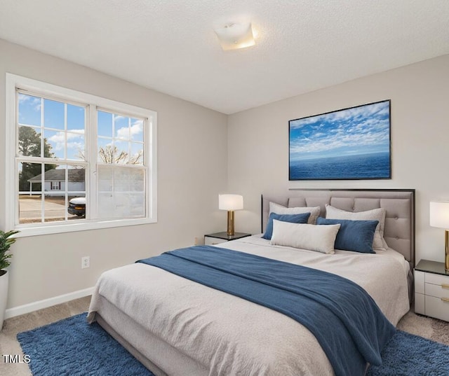 bedroom featuring carpet flooring and a textured ceiling