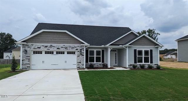 craftsman house with a garage, stone siding, driveway, and a front lawn