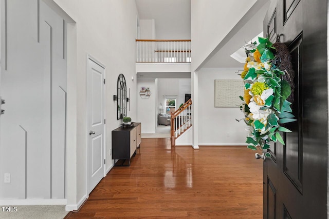 foyer entrance featuring a high ceiling and hardwood / wood-style flooring