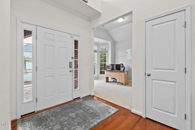 foyer with hardwood / wood-style floors and lofted ceiling