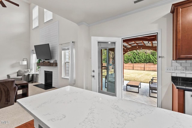 bedroom featuring access to exterior, a large fireplace, and ornamental molding