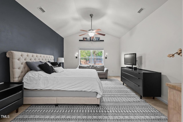 bedroom with ceiling fan, carpet floors, and vaulted ceiling