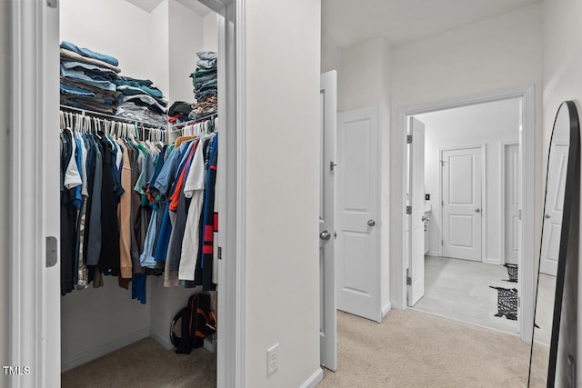 spacious closet featuring light carpet