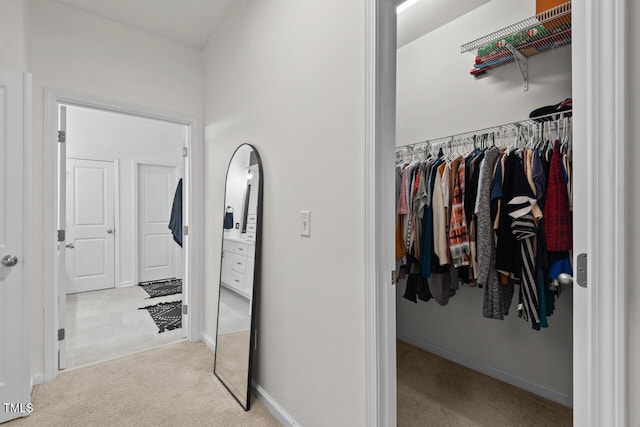 spacious closet featuring light carpet