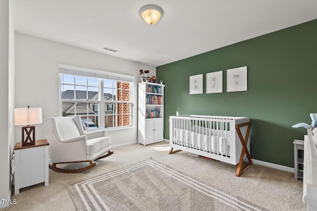 carpeted bedroom featuring a crib