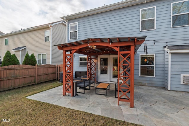 rear view of property with a patio area, a pergola, and a yard