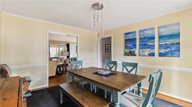 dining room featuring ornamental molding, a textured ceiling, and dark wood-type flooring