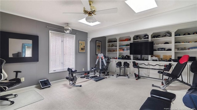 exercise area with ceiling fan, crown molding, and carpet floors