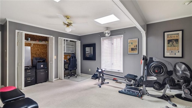 workout room featuring ceiling fan, ornamental molding, and light carpet