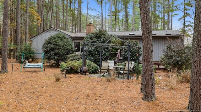 back of property featuring a gazebo