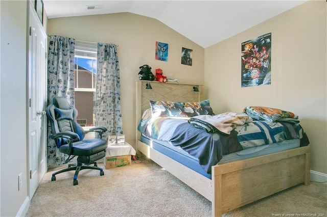 carpeted bedroom featuring lofted ceiling