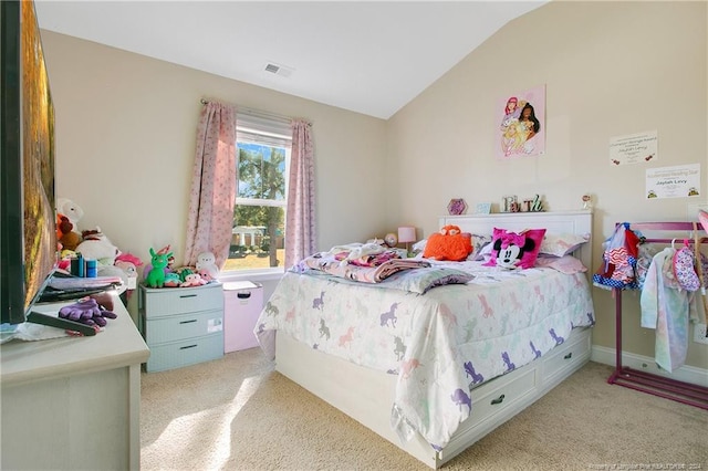 bedroom featuring light carpet and vaulted ceiling