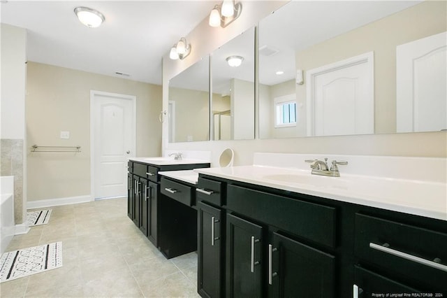 bathroom with a tub to relax in, tile patterned flooring, and vanity