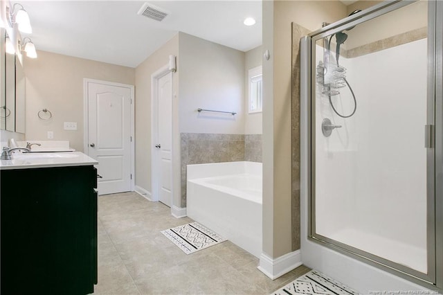 bathroom featuring vanity, tile patterned floors, and separate shower and tub