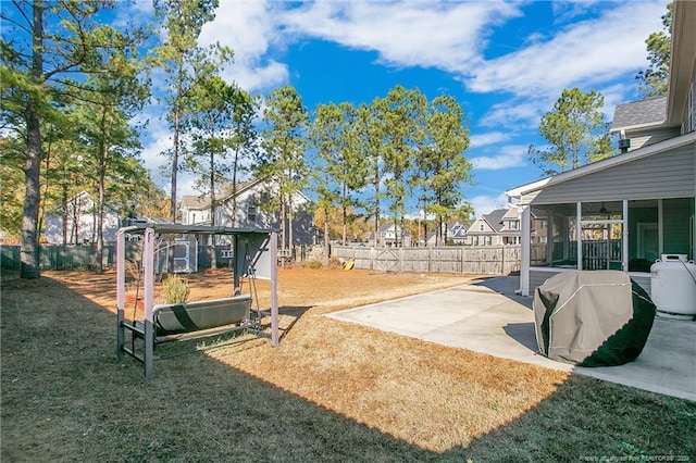 view of yard featuring a patio and a sunroom